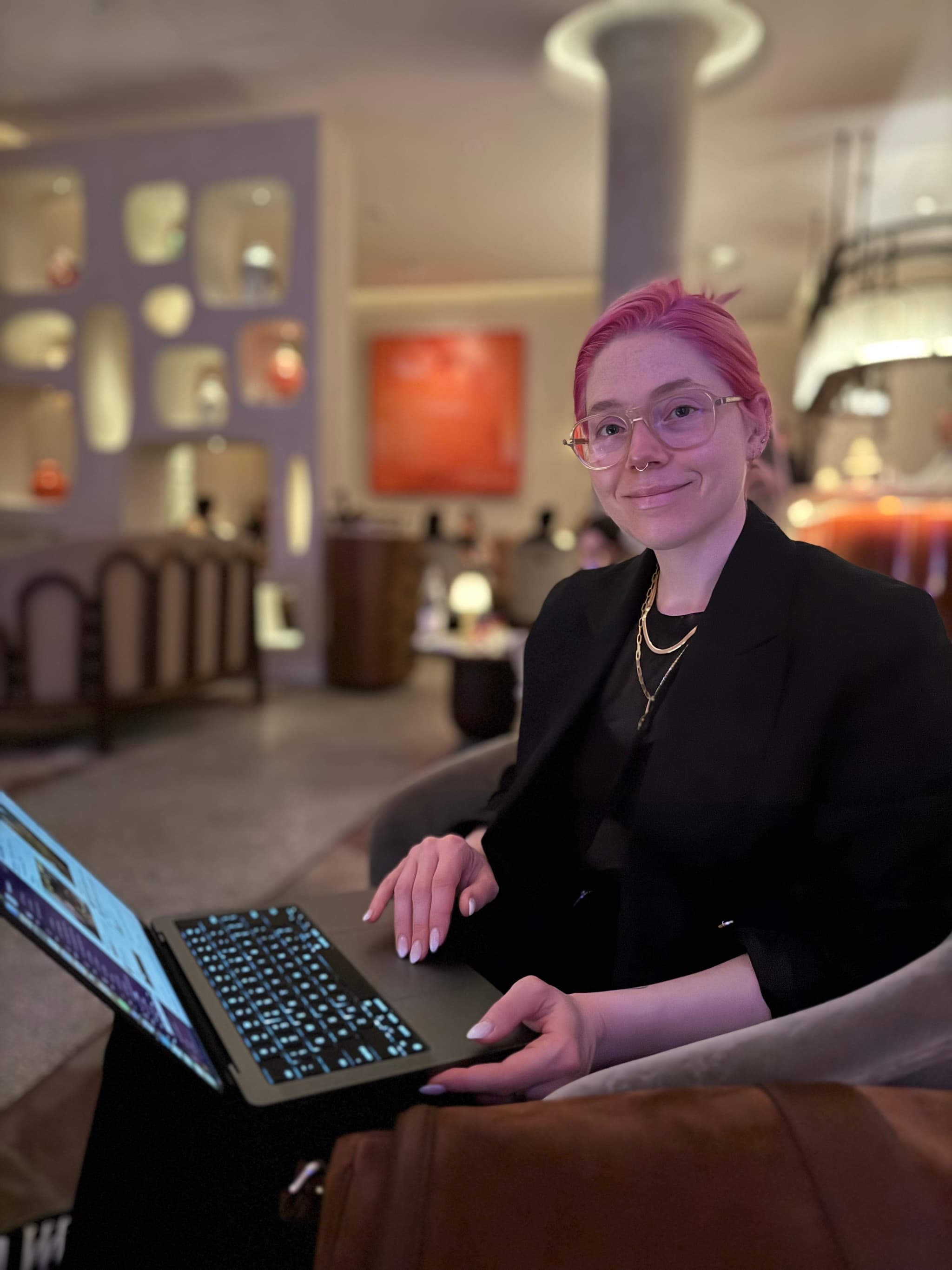 Late-night laptop session in a velvet-lit hotel lounge