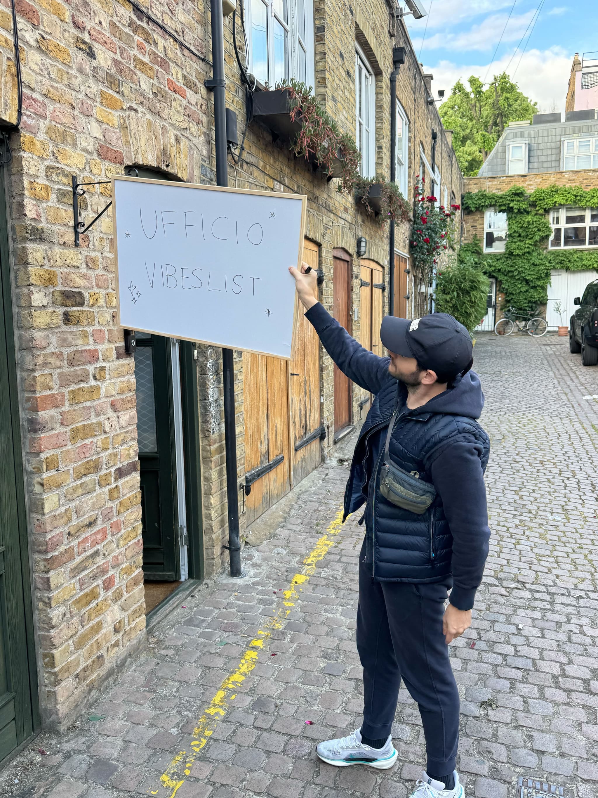 Pop-up “Ufficio Vibeslist” sign outside a London mews studio